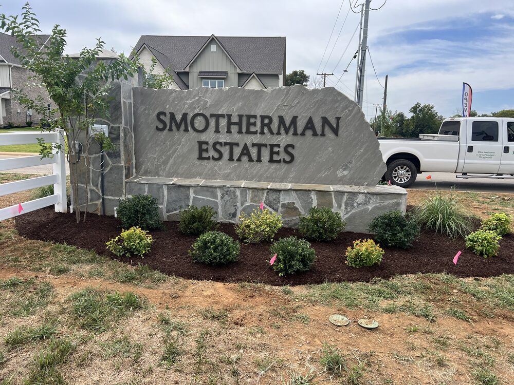 Neighborhood entrance monument sign with planting bed